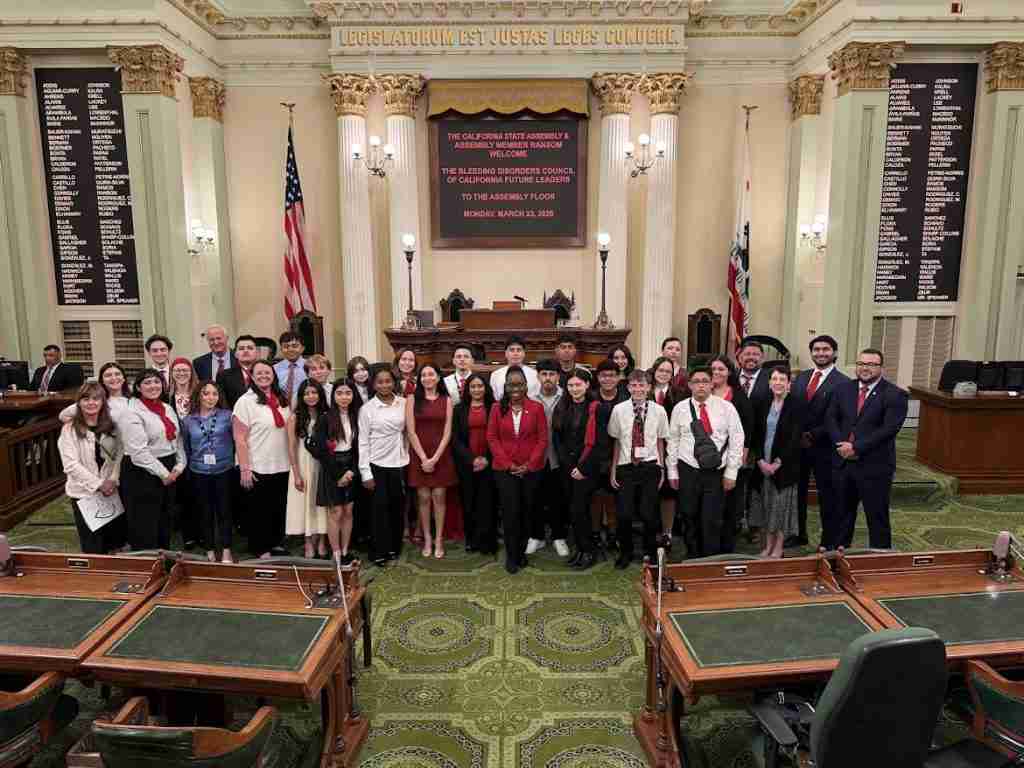 Group photo of Asm Ransom and BDCC Advocates on floor of Assembly